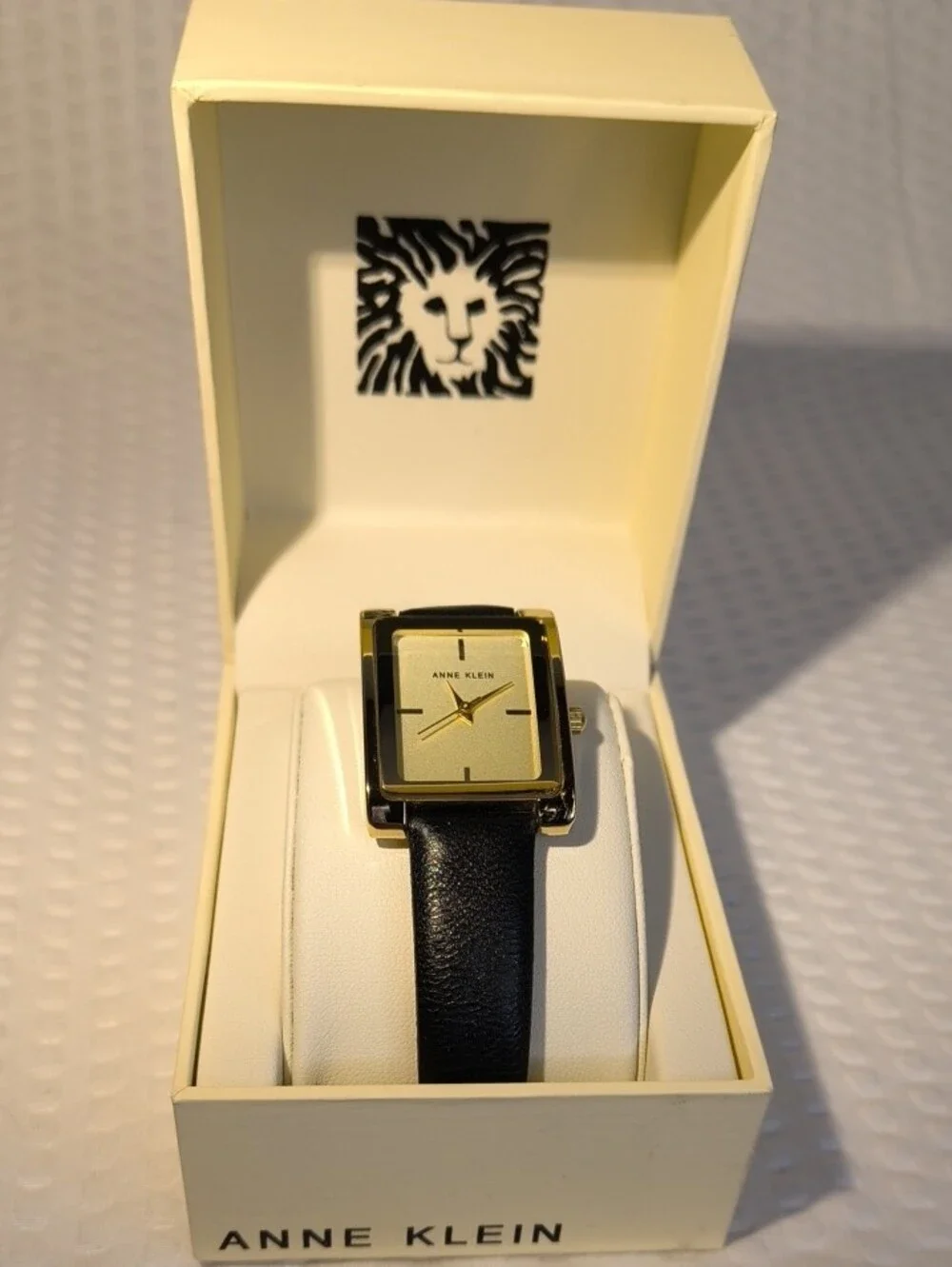 Anne Klein Women's Black Leather Strap Gold-Tone Rectangular Watch
